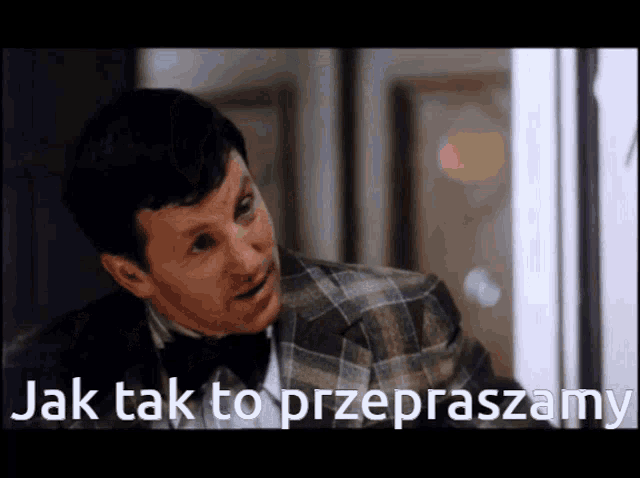 a man in a plaid suit and bow tie says jak tak to przepraszamy in a foreign language
