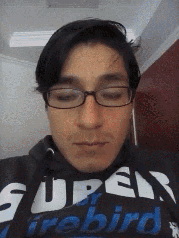 a man wearing glasses is wearing a super firebird sweatshirt