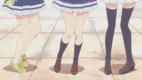 a blurry picture of three anime girls dancing together .