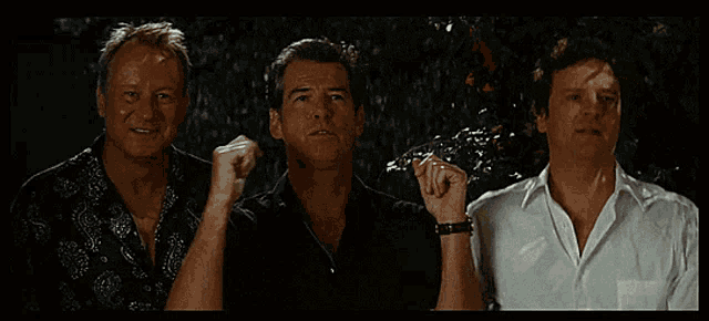 three men standing next to each other with one wearing a watch