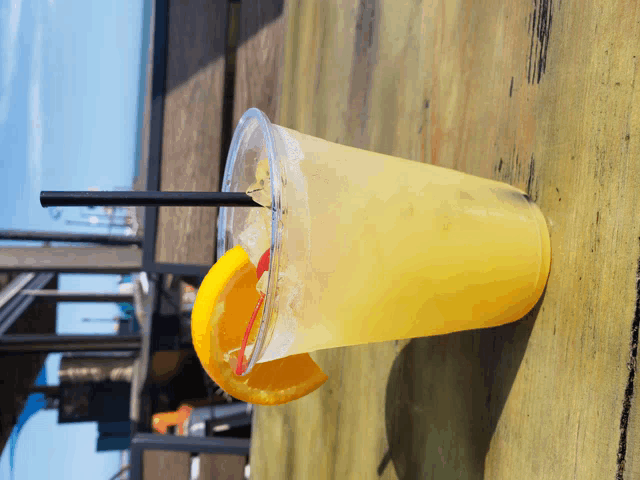 a drink in a plastic cup with a straw