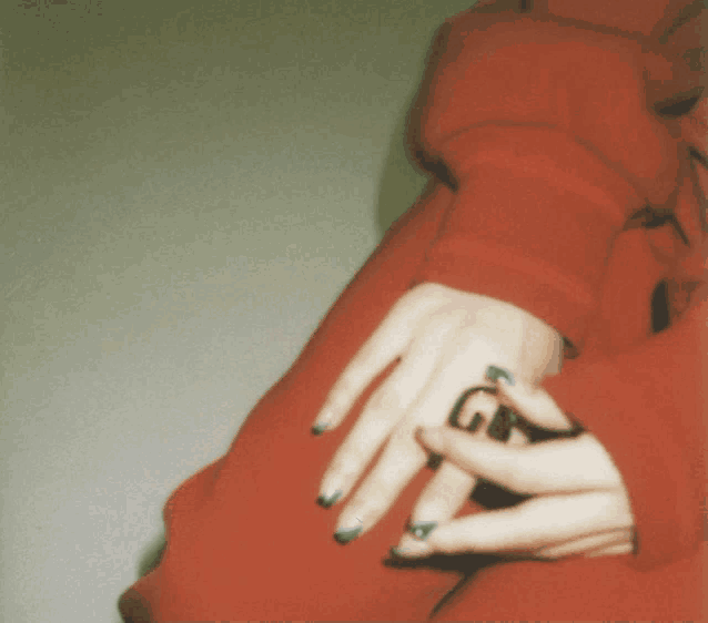 a close up of a person 's hand with a ring that says g on it