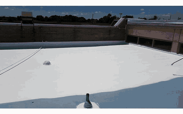 a white roof with a drain hole in the middle of it