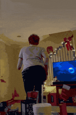 a person is standing in front of a television with a supreme box on the floor