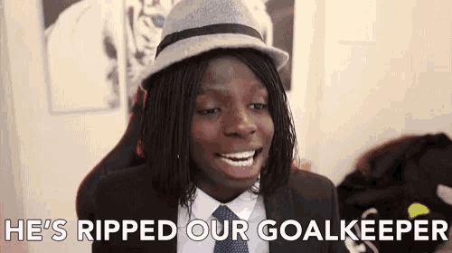 a young man wearing a hat and suit says he ripped our goalkeeper