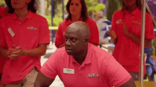 a man wearing a pink shirt with a name tag that says ' scott ' on it
