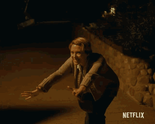 a woman is hugging another woman with a netflix logo in the background