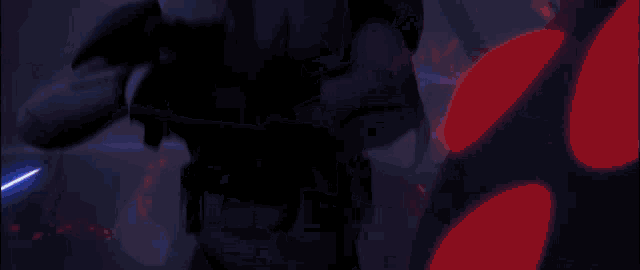 a person in a dark room with a blue light coming out of their chest .