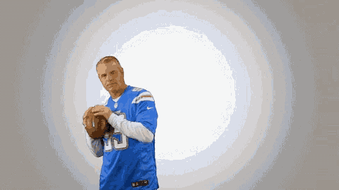 a man in a blue jersey with the number 35 on it is holding a football