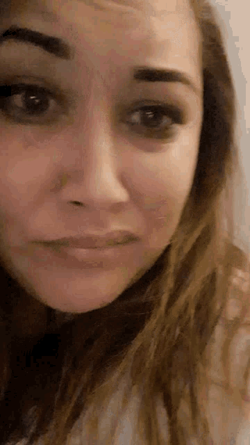 a close up of a woman 's face with her eyes closed