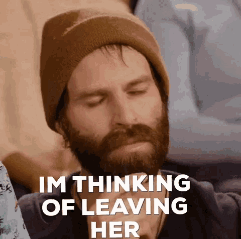 a man with a beard wearing a beanie is thinking of leaving his girlfriend