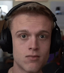a close up of a man wearing headphones and looking at the camera