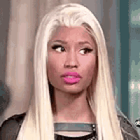 a close up of a woman with long blonde hair and pink lips .