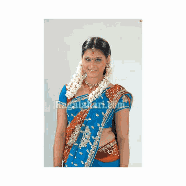 a woman is wearing a blue and orange saree with the website ragalahari.com in the corner