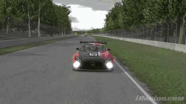 a red and black car with the number 73 on the front is driving down a road