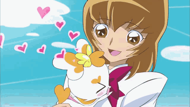a girl holding a stuffed animal with hearts coming out of it 's eyes