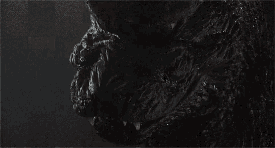 a close up of a monster 's face with its mouth open and sharp teeth .