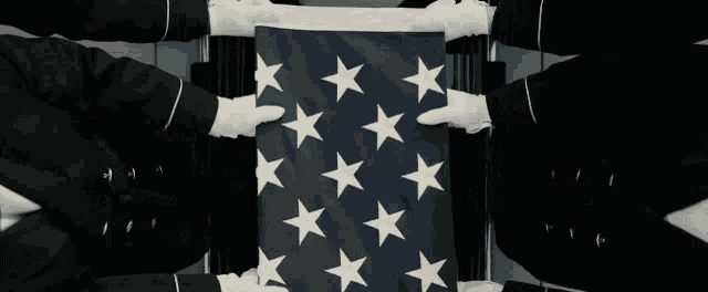 a group of people holding an american flag with a superman logo on it