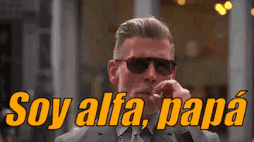 a man wearing sunglasses and a suit says soy alfa papa in spanish