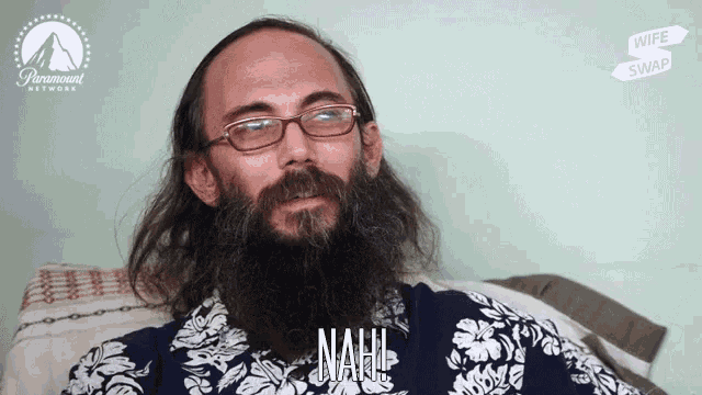 a man with a beard and glasses is wearing a shirt that says nah