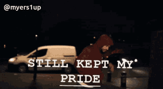 a man in a red hoodie stands in front of a white van with the words still kept my pride below him