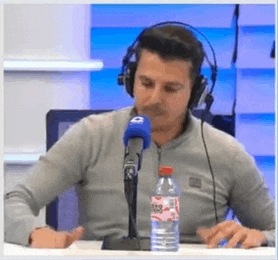 a man wearing headphones is speaking into a microphone