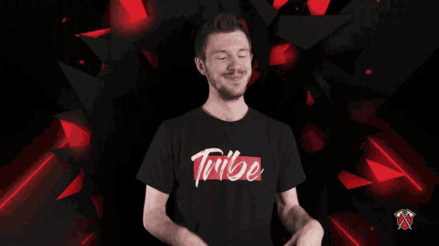 a man wearing a tribe t-shirt making a heart shape with his hands
