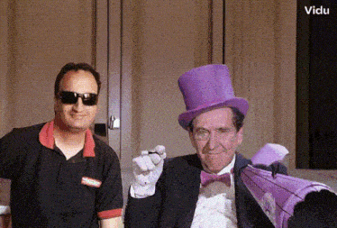 a man wearing sunglasses stands next to a man in a top hat and bow tie