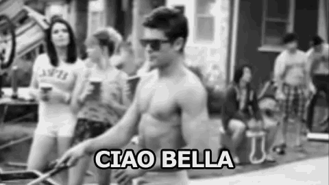 a shirtless man wearing sunglasses is walking down a street with a group of people .