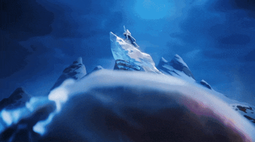a person standing on top of a snowy mountain with a large ice sculpture in the background