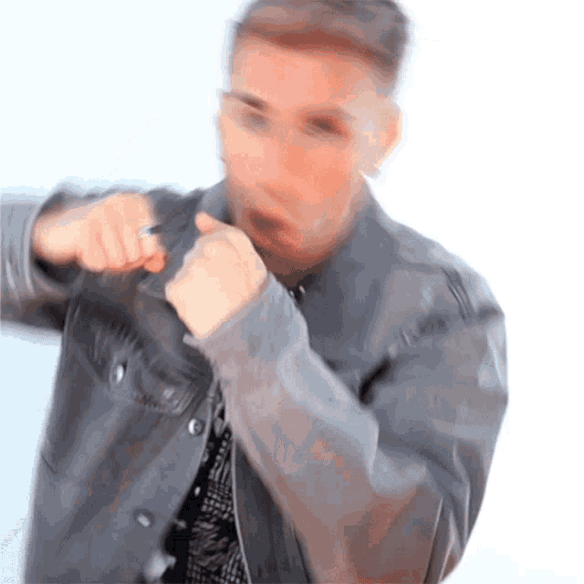 a blurry picture of a man in a leather jacket
