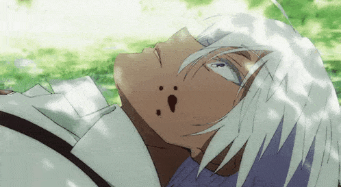 a close up of a person 's face with white hair laying down .
