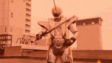 a ghost rider from kamen rider ghost is holding a sword in front of a building .