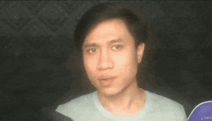a man in a blue shirt looks at the camera