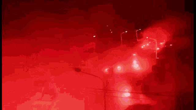 a man in a dodgers jersey is standing in front of a red light .