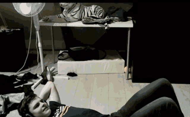 a man wearing headphones is laying on the floor