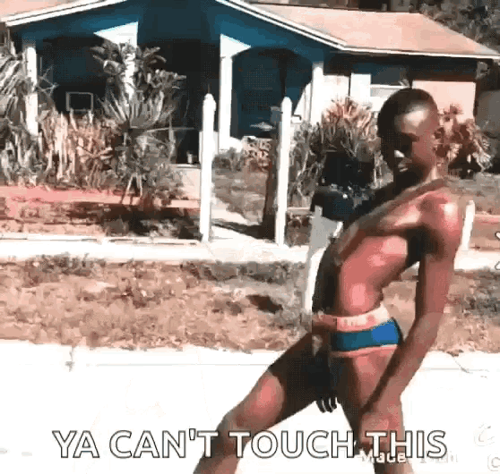 a woman in a bathing suit is dancing in front of a house .