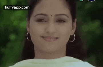 a close up of a woman 's face with a smile on her face .