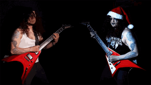 a man wearing a santa hat playing a guitar