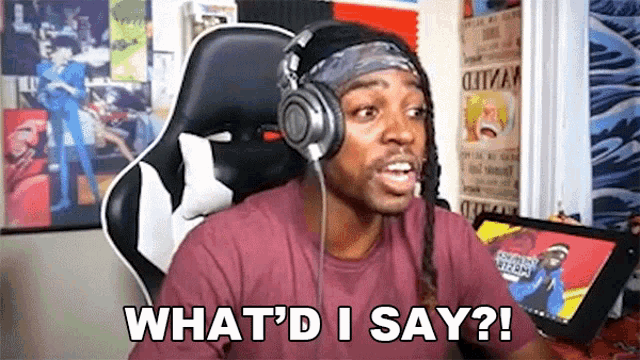 a man wearing headphones and a headband is sitting in a chair and says `` what 'd i say ? ''