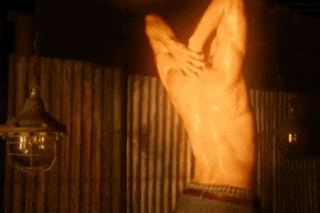 a man without a shirt is hanging upside down