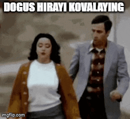 a man and a woman are walking down a street with a caption that says " dogus hirayi kovalaying "