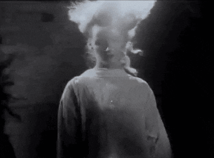 a black and white photo of a person with smoke coming out of their head .