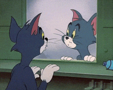a cartoon of tom looking at himself in the mirror