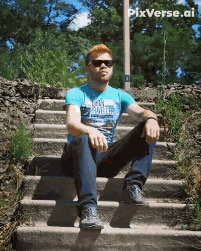 a man wearing a urban traveler shirt sits on a set of steps