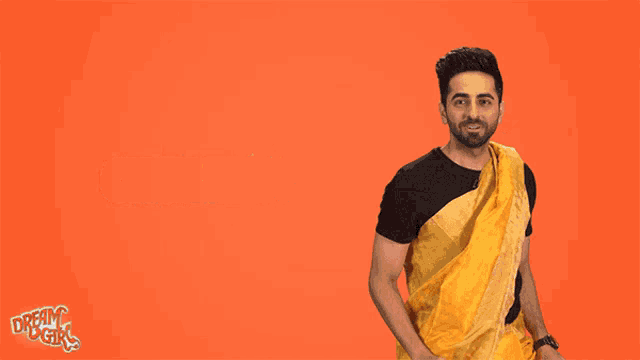 a man in a yellow saree is standing in front of a sign that says hal i ?