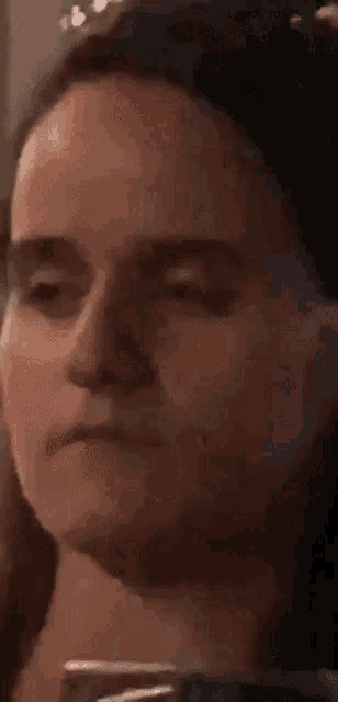 a close up of a woman 's face making a funny face .