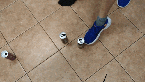 a can of energy drink is on the floor