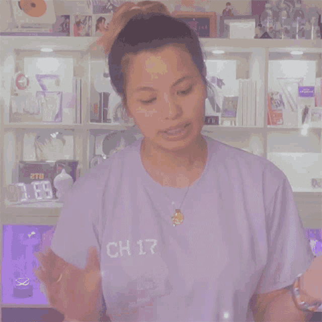 a woman in a purple shirt that says ch 17