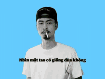 a man smoking a cigarette in front of a blue background with vietnam in black letters